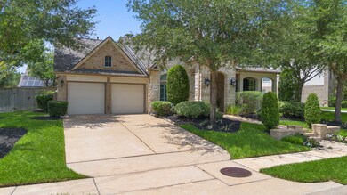 The front-facing garage features a wide, paved dri