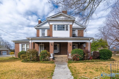 This is the side entrance from Pearl Street. The front porch wraps around with plenty of space for outside entertaining. The home is situated on a corner lot.