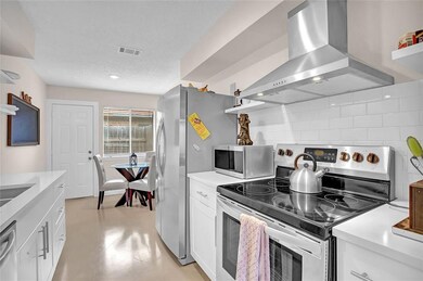 Kitchen with visible vents, open shelves, wall ch