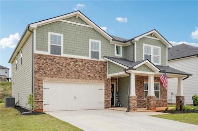 Craftsman inspired home featuring stone siding, co