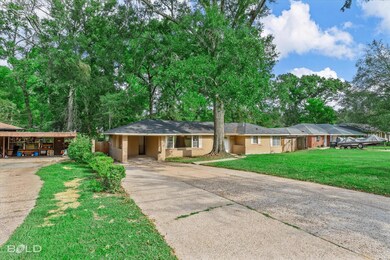 Ranch-style home with a front yard and a carport