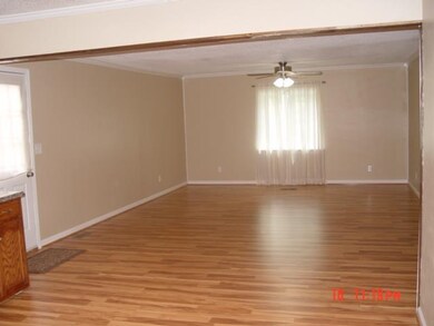 View of large living room with new window and new laminate flooring