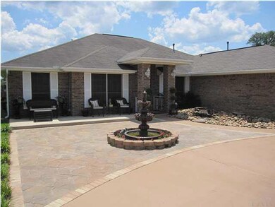 Stone pavers extend beyond driveway to the sitting area at the front of the home. Owners have created an open front porch area. New outdoor carpet added 4/2012.
