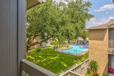 View of the pool from primary bedroom balcony.