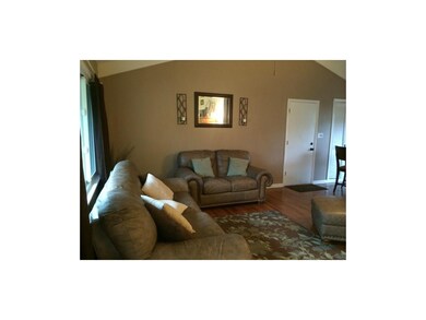 Wood floors and vaulted ceilings welcome you as yo