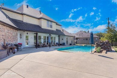 View of pool with ceiling fan and a patio area