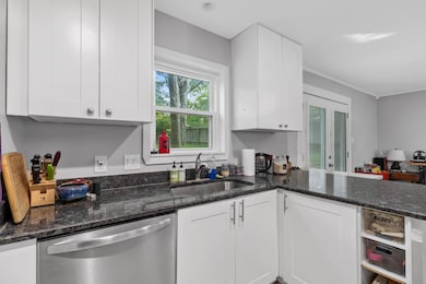 Kitchen with stainless steel dishwasher, a sink, 