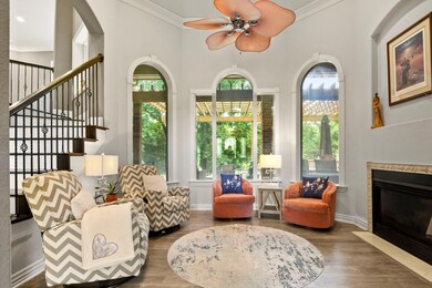 Living room with crown molding, dark hardwood / wood-style floors, and ceiling fan