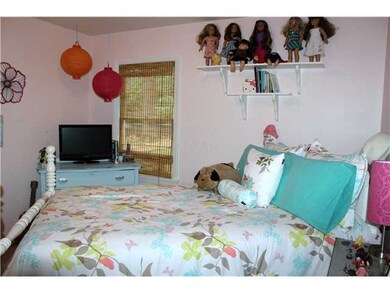 Another view of the third bedroom showing the seco