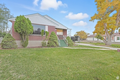 View of front of house featuring a front yard and brick siding