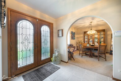 Welcoming foyer features custom wood and leaded gl