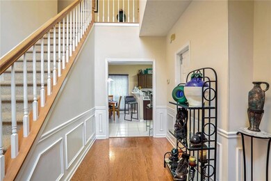 Open Foyer featuring hard wood flooring and waines
