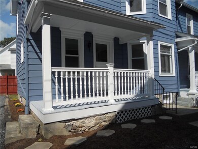 The back porch has an access door to the basement