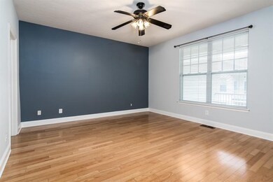 Bedroom with hardwood flooring and ceiling fan