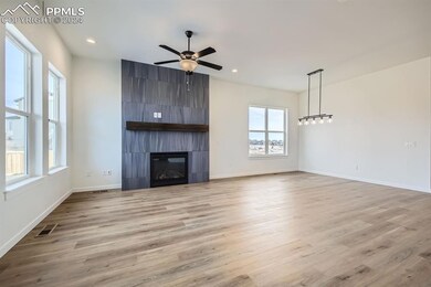 Unfurnished living room featuring a fireplace, lig