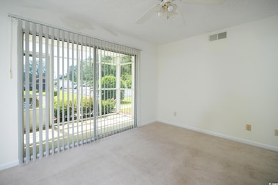Empty room with carpet, baseboards, a ceiling fan,