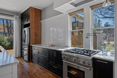 Gorgeous sun drenched kitchen has glossy charcoal 