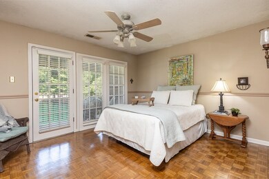 Bedroom featuring ceiling fan, parquet flooring, a