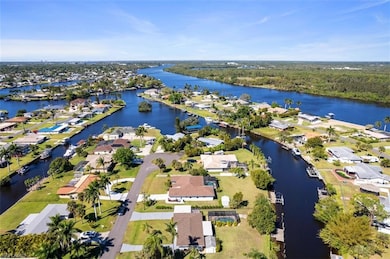 Aerial view of property's location featuring a nearby body of water and nearby suburban area