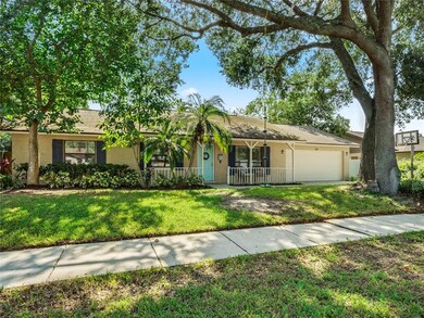 Mature landscape and a darling front porch greet y