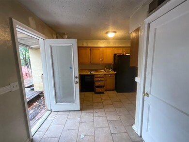 Kitchen featuring black appliances, light tile pat