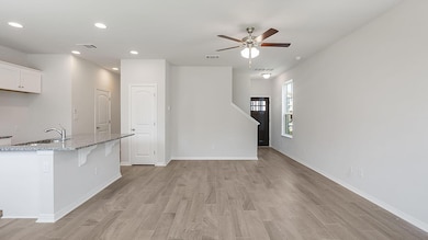 Unfurnished living room with a ceiling fan, light