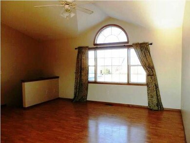 Large open living room with wood laminate floors.