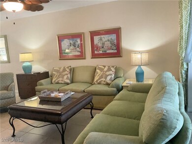 Tiled living room featuring ceiling fan