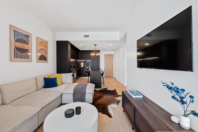 Living area with light wood-style flooring, a cha