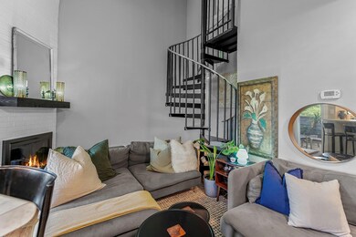 Living area featuring a high ceiling, stairway, a