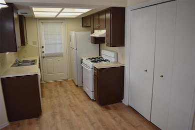 Kitchen with white gas range oven, under cabinet 