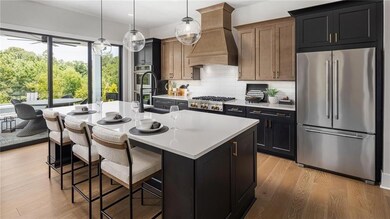 Kitchen featuring appliances with stainless steel finishes, abundance of natural light, light countertops, backsplash, and recessed lighting. Photos are of the Tallulah Model Home and are not representative of actual home. Designer features may vary.