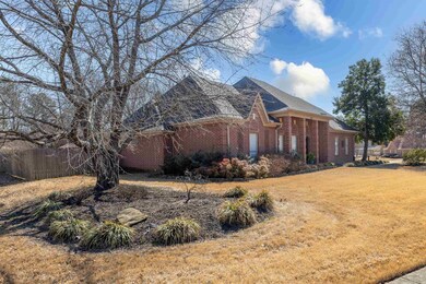View of side of property with a yard, fence, and b