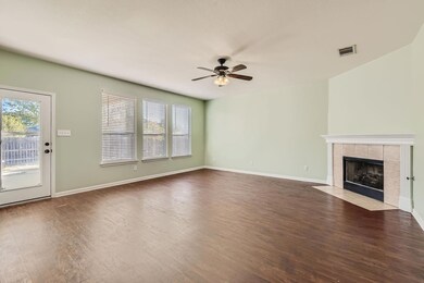 Unfurnished living room with ceiling fan, wood fi
