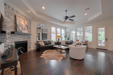 Living room with gas log fireplace, eng. wood floo