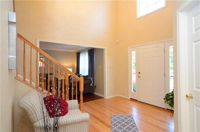 Dramatic two-story foyer with re-sanded hardwood f