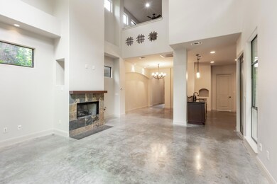 Unfurnished living room featuring finished concre