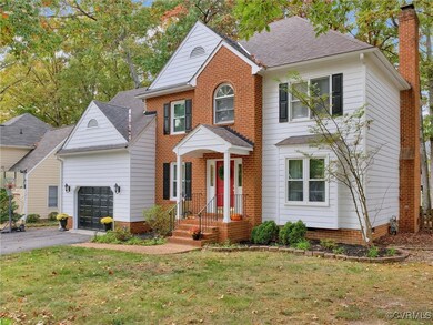 View of front of house with a front lawn and a gar