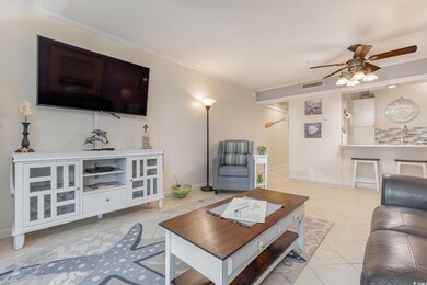 Tiled living room with crown molding, ceiling fan,
