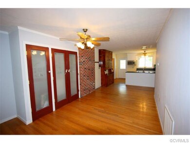 Foyer leading into kitchen. There is a large pantr