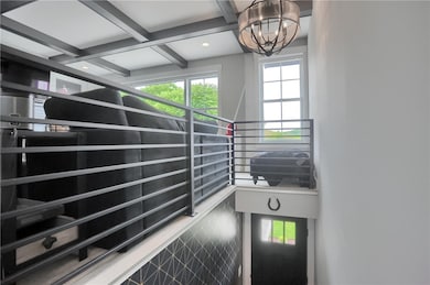 Sleek metal railings and a statement chandelier el