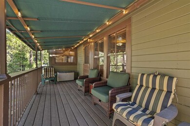 Front deck, with cloth awning, entry to living room. Lake views from deck.