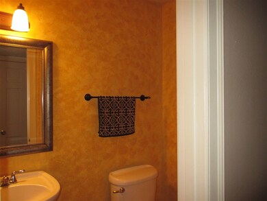 Half bath tucked off hallway beside kitchen. Conve