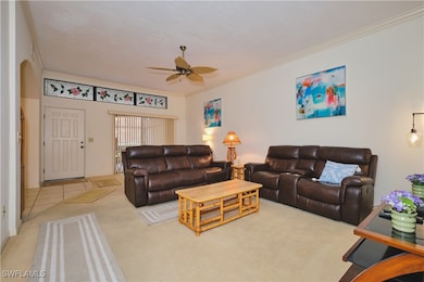 Living room with carpet flooring, arched walkways,