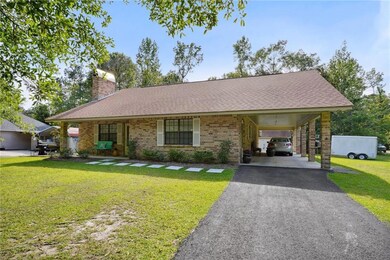 Carport provides covered parking and covered sitting area.