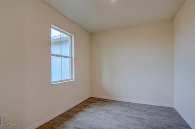 Spare room with light wood-style tile floors
