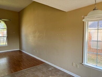 Empty room with tile patterned flooring, vaulted c
