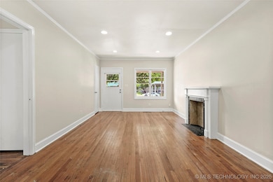 Unfurnished living room featuring hardwood / wood-