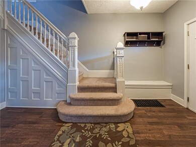 A sizable foyer with historic charm and wood work 
