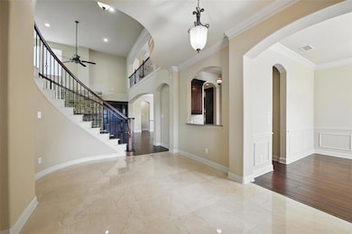 Entryway featuring stairway, ornamental molding, m
